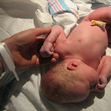 Holding on to Daddy's finger at about 5 minutes old