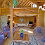 The living room, river rock fireplace and grand piano.