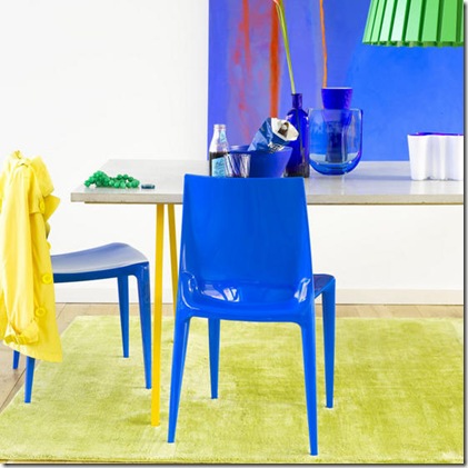 Bright bold blue dining room plastic chairs concrete table blue bowl vase abstract painting green rug L etc 06/2007 pub orig Bright bold blue dining room plastic chairs concrete table blue bowl vase abstract painting green rug L etc 06/2007 pub orig