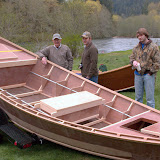 Roger Fletch, Sanderson Dersham, and Austin Willhite look over a new Tatman Wooden Boat