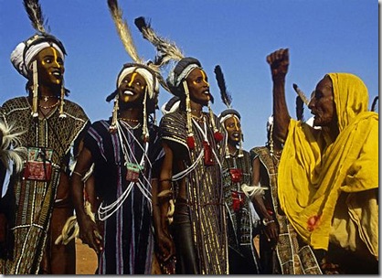 A female judge urges Wodaabe male dancers to exaggerate their facial expressions, in Niger in 1996