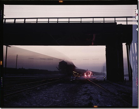 View in a departure yard at Chicago and Northwestern Railway Company's Proviso yard at twilight. Chicago, Illinois, December 1942. Reproduction from color slide. Photo by Jack Delano. Prints and Photographs Division, Library of Congress