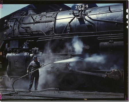 Mrs. Viola Sievers, one of the wipers at the roundhouse giving a giant "H" class locomotive a bath of live steam. Clinton, Iowa, April 1943. Reproduction from color slide. Photo by Jack Delano. Prints and Photographs Division, Library of Congress