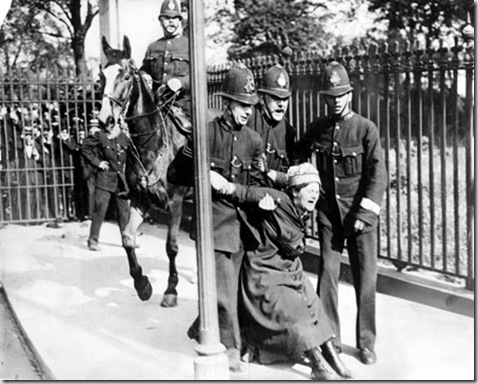 A woman campaigning for the vote is restrained by policemen. British women did not win full voting rights until 1928.


