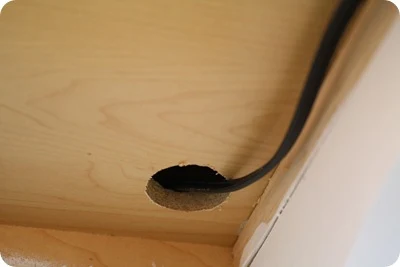 hole drilled under cabinet