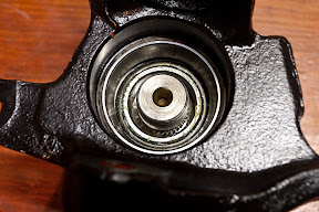 Hub partly through the front wheel bearing