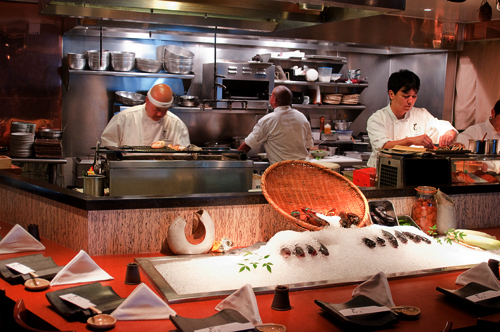 Seating surrounding the open kitchen and sushi bar