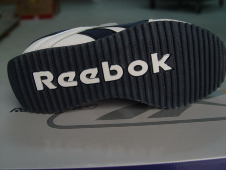 Reebok in white text on the black sole of a shoe.