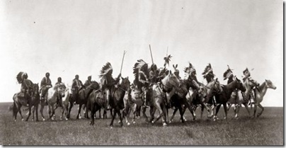 Brulé Indians, many wearing war bonnets, on horseback. Photo by Edward S. Curtis, December 26, 1907 