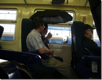 man-use-umbrella-inside-the-bus