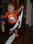 Before the party, Noah pulled the toilet paper all the way into the kitchen.