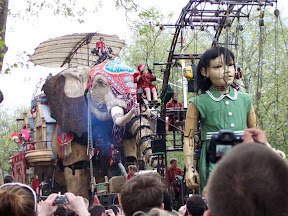 The little girl leads the Elephant down the Mall