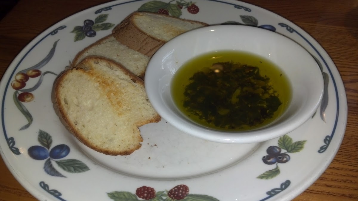 Lightly toasted GF french bread with olive oil dip.