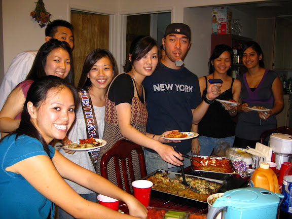 crowd around the food! im serving paulas delicious pasta, and ethan is serving stouffers lasagna.. it was actually really good, haha.