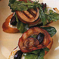 Grilled Bread Topped with Arugula, Goat Cheese, Olives and Onions