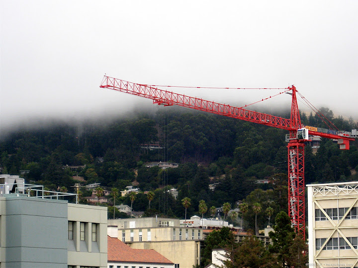 Crane, fog, hills