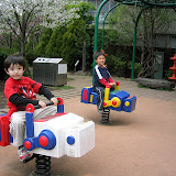 Kai and Kento riding the robots at Robot Park