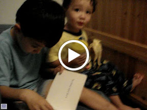 Kai reading to Eidan, with Eidan providing sound effects
