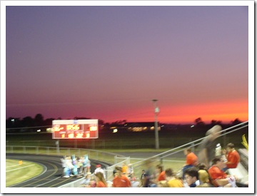 sunset behind the scoreboard Friday night.