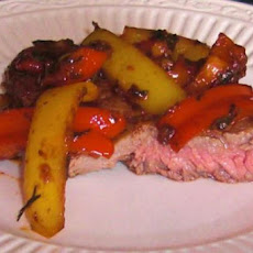 Steak Topped With Peppers and Onions