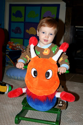 riding his cross-eyed but cute caterpillar rocker