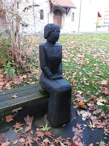 Sitting Woman in Front of a Church