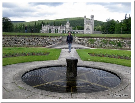 Balmoral Castle viewed from the grounds. The fountain is an old mooring bollard from Aberdeen.