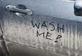 c0 This car door has 'wash me' written on it
