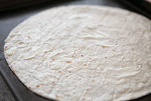 spread the flour tortilla all over with butter