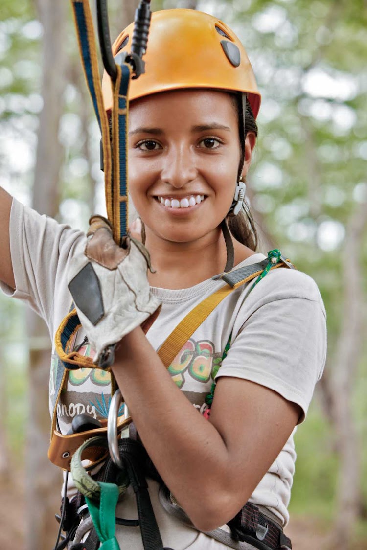 A local woman preps for a zipline during a canopy tour in Huana Coa, north of Mazatlan, Mexico.