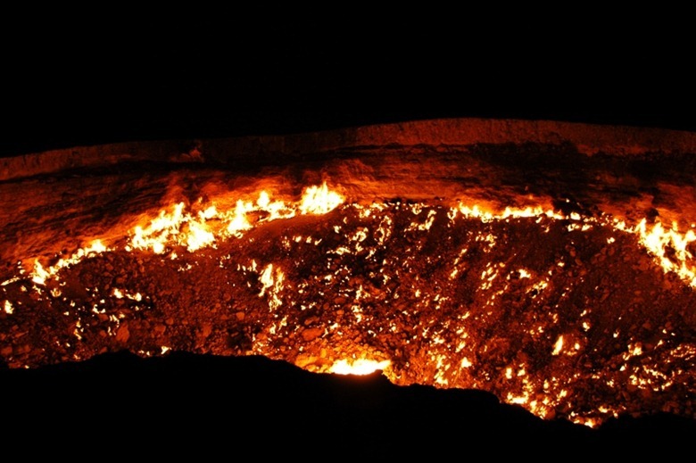 Perhaps the most accurate, living representation of hell we've ever seen, flames lick up, fueled by escaping natural gas at the Darvaza gas crater.  <br /><br />We spent a remarkably peaceful night camping at the crater's edge.