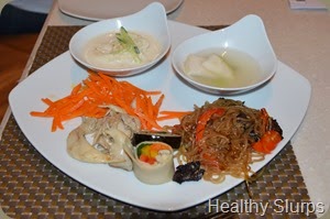 Clockwise - Cold Noodles, water kimchi, japchae, Gimbap, and some salad
