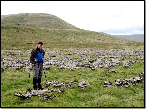Mick on the Scales Moor limestone pavement, with Whernside behind