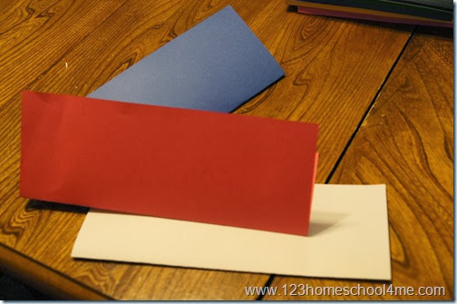 fold red, white, and blue paper in half lengthwise fold red, white, and blue paper in half lengthwise