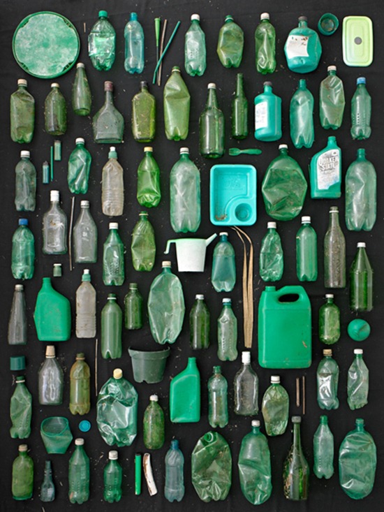 green plastic and glass containers on black background 