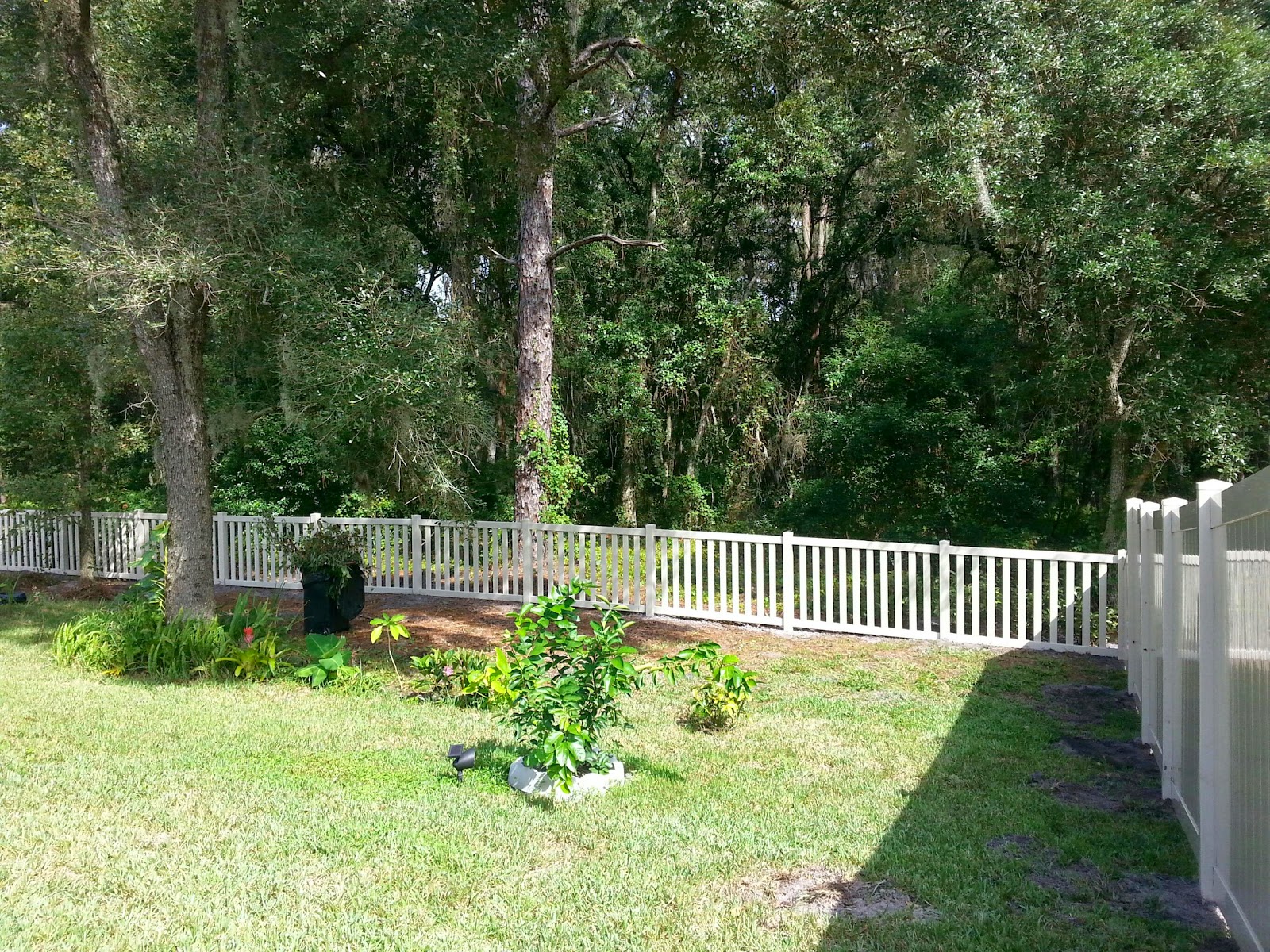 New Tampa Fence Inc Vinyl fence down the hill