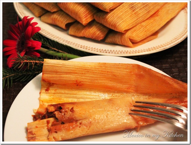 cooked pork tamales in a corn husk