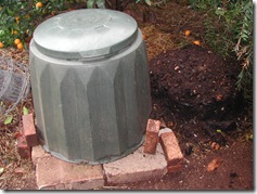 A Gedye Bin (left) produces rich fertile soil (right) from household scraps. The bin sits upon a brick base that prevents mice from tunneling up inside it looking for a free feed and a warm home.
