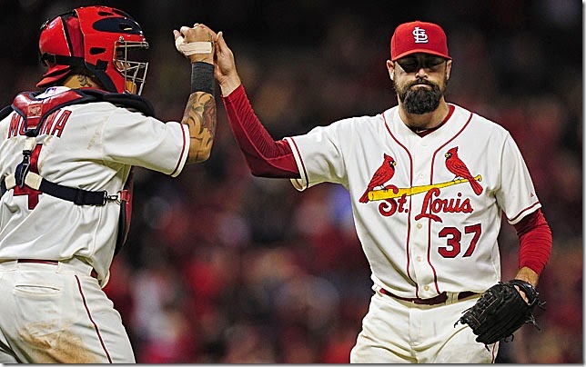 Sep 13, 2014; St. Louis, MO, USA; St. Louis Cardinals relief pitcher Pat Neshek (37) celebrates with catcher Yadier Molina (4) after defeating the Colorado Rockies 5-4 at Busch Stadium. Mandatory Credit: Jeff Curry-USA TODAY Sports