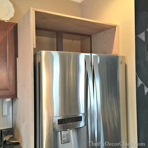 building in fridge with cabinet on top