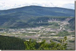 Industrial area of Dawson City, YT.  Tailing piles of rocks at bottom of picture
