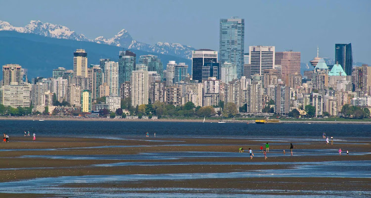 The view of the Vancouver skyline from Kitsilano at low tide