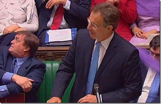 BRITAIN'S PRIME MINISTER BLAIR REACTS AS PAINT BALL IS THROWN FROM GALLERY AT HOUSE OF COMMONS IN LONDON...Britain's Prime Minister Tony Blair (C) reacts with Deputy Prime Minister John Prescott (L) and Chancellor of the Exchequer Gordon Brown (R) after a powder paint ball (right, obscuring face of Brown) is thrown from the gallery during Prime Minister's Questions at the House of Commons in London, May 19, 2004. British members of parliament were forced to evacuate the House of Commons chamber on Wednesday after the incident. Fathers' rights group "Fathers 4 Justice" claimed responsibility for targeting the prime minister, the BBC reported, dispelling fears of a terror attack.  EDITORIAL USE ONLY, NO ARCHIVE, NO SALES REUTERS/PARBUL