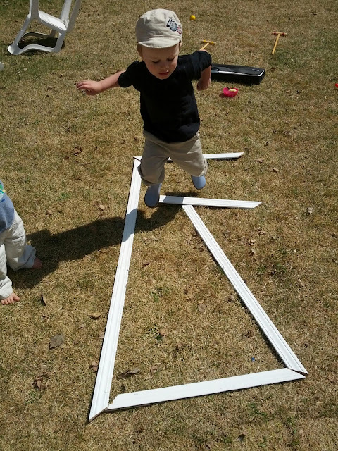 Kid jumping over DIY giant outdoor letters