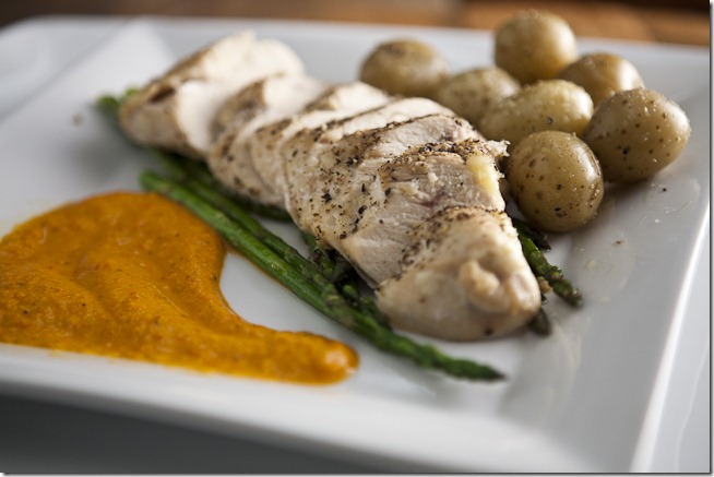 Oven Roasted Seasoned Chicken Breast over Garlic Sauteed Asparagus with Colombian Baby Potatoes and Red Pepper Sauce