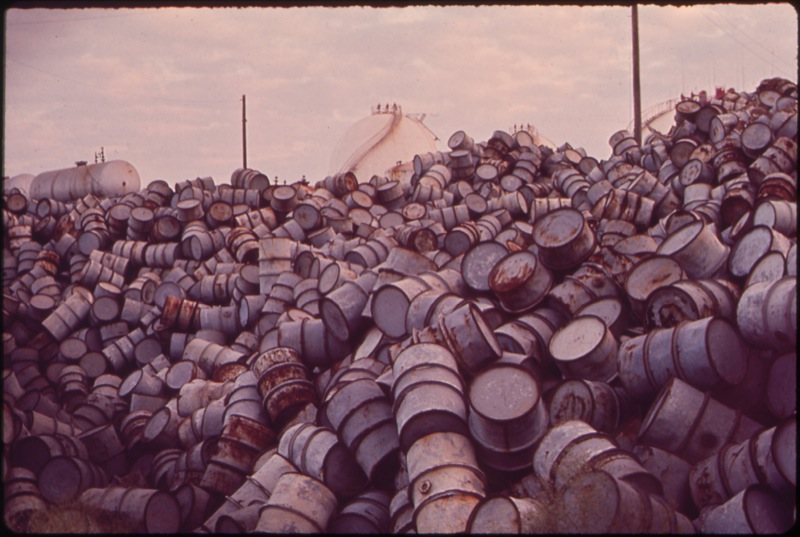 CC Photo Google Image Search.  Source is upload.wikimedia.org  Subject is A Mountain of Damaged Oil Drums Near the Exxon Refinery.jpg