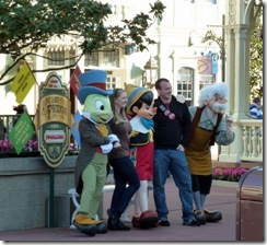 Disney characters pose with a young couple