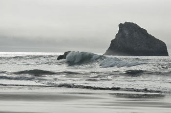 surf at Harris Beach on a cloudy grayish day