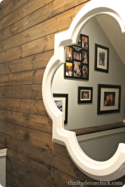 White mirror over wood wall