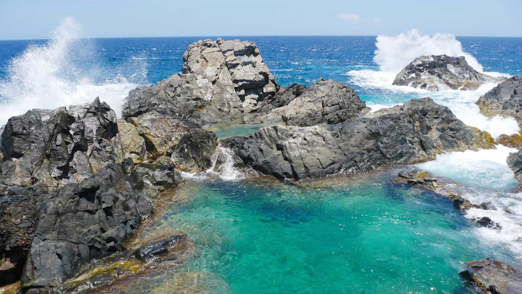 Rocky crags form a tidepool along the coast of Aruba.